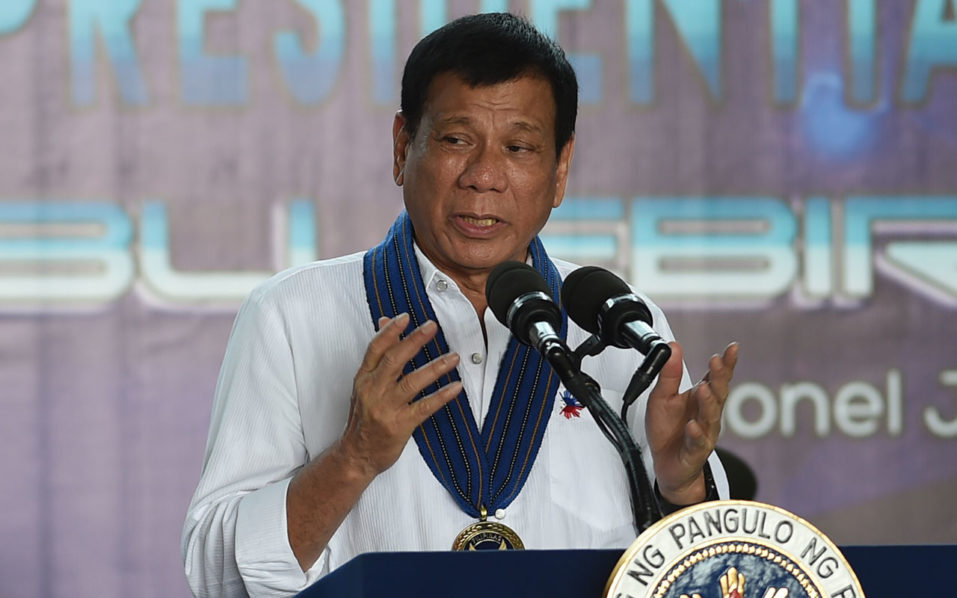 Philippine President Rodrigo Duterte gestures as he delivers his speech during the 250th Presidential Airlift Wing Command anniversary celebrations at Villamor air base in Manila on September 13, 2016.  The Philippines assured the United States September 13 it will honour its obligations as a military ally following volleys of profane tirades by unpredictable President Rodrigo Duterte. / AFP PHOTO / TED ALJIBE